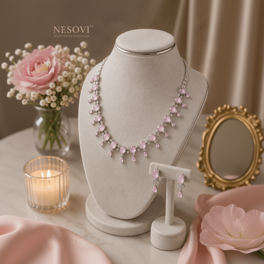 A pink gemstone necklace and matching drop earrings.