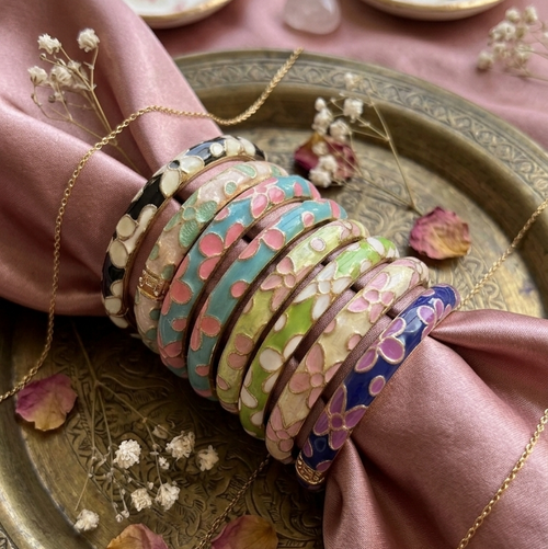 Colorful Meenakari Kada bangles on a pink satin fabric
