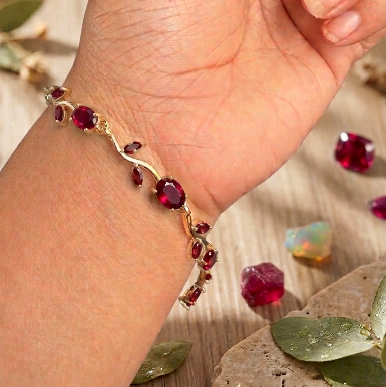 gold-toned vine bracelet with red gemstone