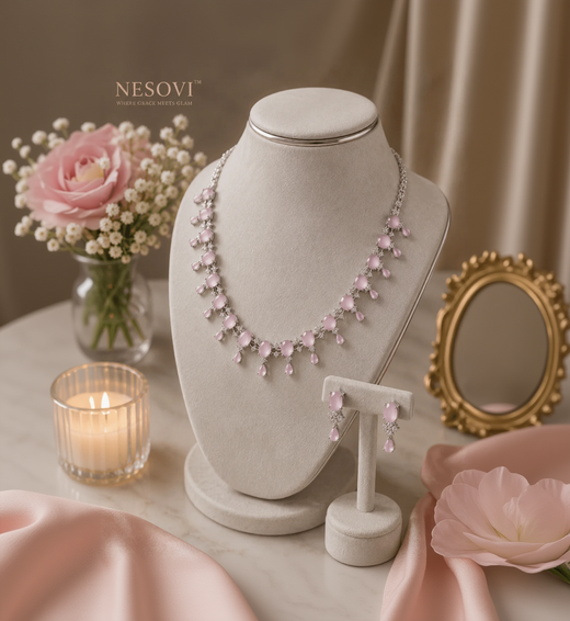 A pink gemstone necklace and matching drop earrings.