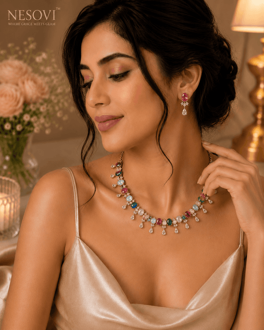 A woman wearing a colorful gemstone necklace and matching drop earrings by Nesovi